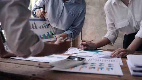 Closeup business people are working on their business. Discussed about paperwork that shows chart