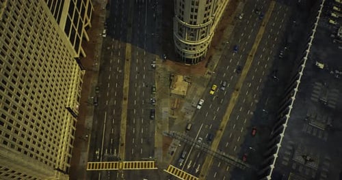 Urban Intersection Bustling with Vehicles and Pedestrians in the City at Dusk