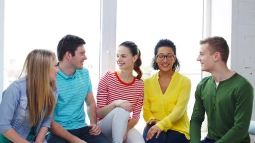 Group of Friends Talking and High Fiving Indoors