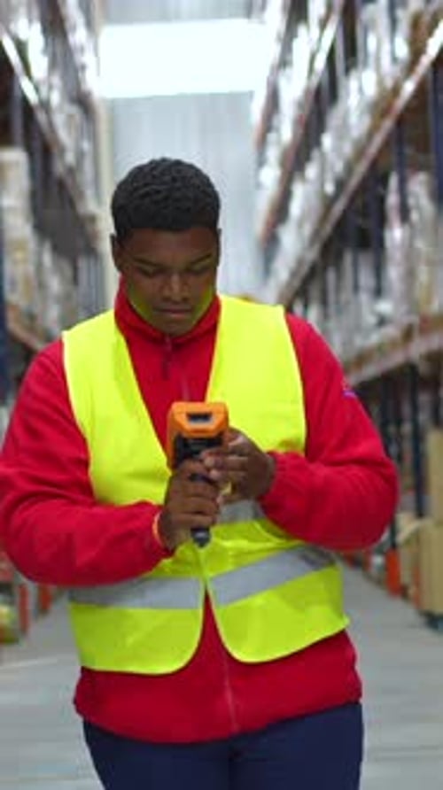 Latin Worker Scanning Products From Shelves in Distribution Warehouse