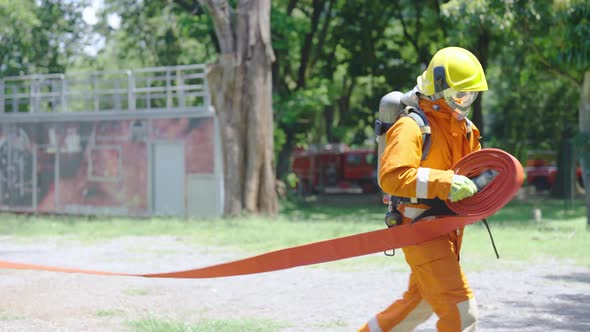 Wide shot of fireman or firefighter resemble and expand fire pipe line ...