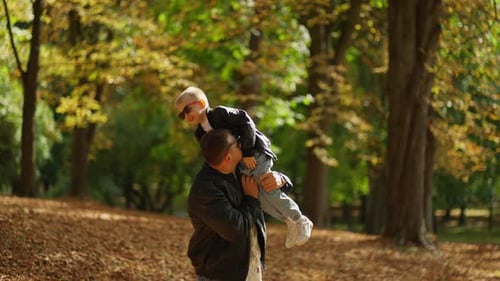 Father Lifts His Son Into Air Concept of Parental Care