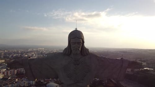 Stunning back and up drone flight away from Cristo rei Jesus Christ in Portugal Lisbon with Sundown
