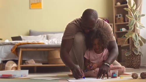 Adult and Child Drawing Together at Home