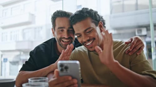 Couple Gays Greeting Video Call By Smartphone in Cafe Close Up Online Meeting