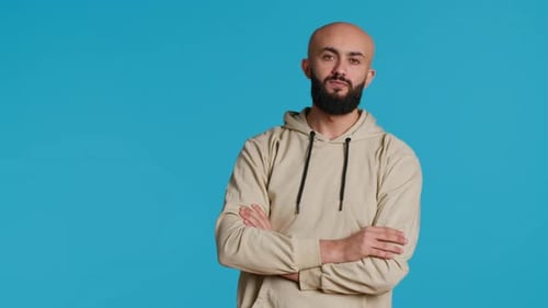 Young Adult in a Hoodie Waiting for Something in Studio