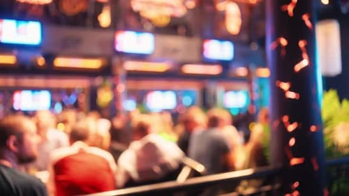 Experience a Vibrant and Energetic Atmosphere Found in a Lively Bar with Crowded Seating and