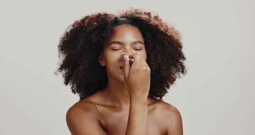 Studio, woman and brush for make up, glow and foundation for skin with cosmetics