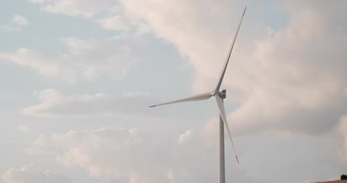 Aerial shot of wind turbines agains cloudy sunset sky