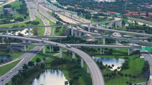 Aerial View of American Freeway Intersection with Fast Driving Cars and Trucks in Miami Florida USA