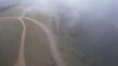 Car on a foggy mountain road