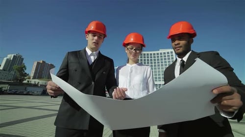 Selbstbewusste Architekten überprüfen einen Geschäftsplan vor Ort