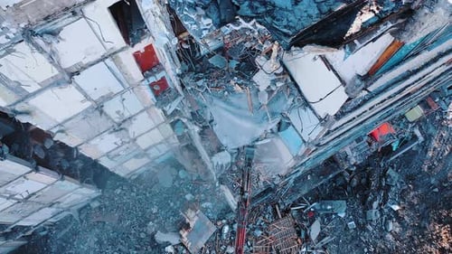 Excavator Demolishing Building Structure from Aerial View