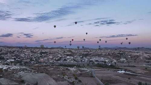 Colorful Balloons Floating Over Turkish Landscape at Sunrise
