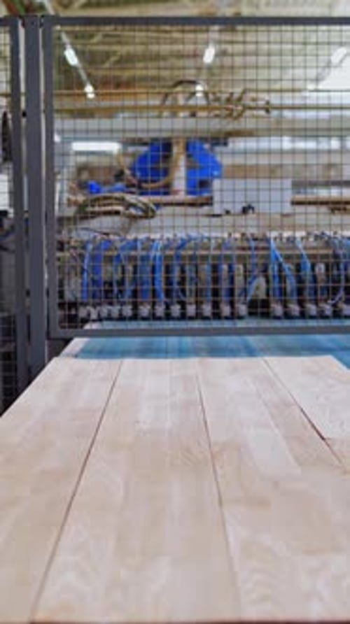 Modern wooden industry. Robotic machine working on a factory for producing wooden laminate.