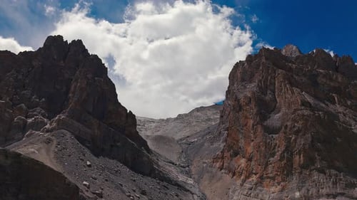 Massive Rocky Peaks and Narrow Mountain Pass Drone View