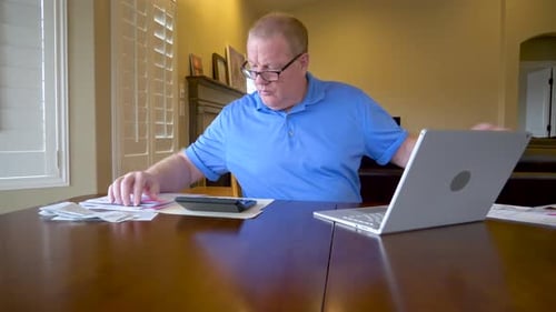 Adult Working on Laptop at Dining Room Table