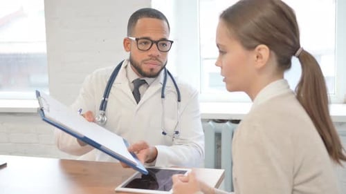 Doctor Consults Patient in a Bright Office