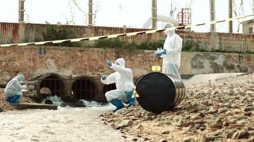 Scientists in Suits Collect Water Samples near River