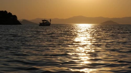 Sunset over Sea with Silhouette of a Boat