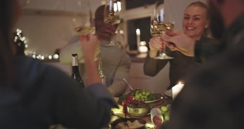 Friends Toasting Wine at Dinner Party Celebration Indoors