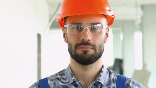Portrait of a Builder or Architect on the Construction Site of Modern Office Centre