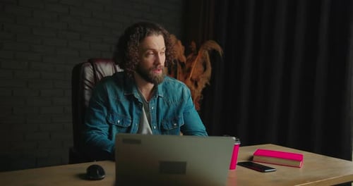 Adult Man Video Call On Laptop In Modern Office