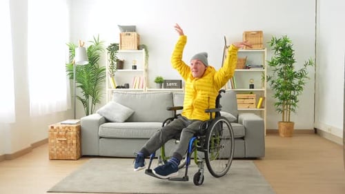 Man in Wheelchair Dancing in Living Room