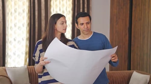 Indian couple discussing house plan