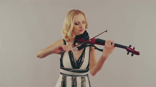 Blonde Woman Plays Electric Violin in Studio