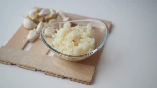 Close Up of Minced Garlic on a Wooden Spoon