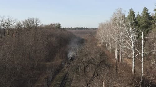 Aerial View of Old Steam Train Running on the Tracks in the Countryside