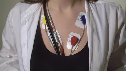 Woman Wears Heart Monitoring EKG Stickers on Chest