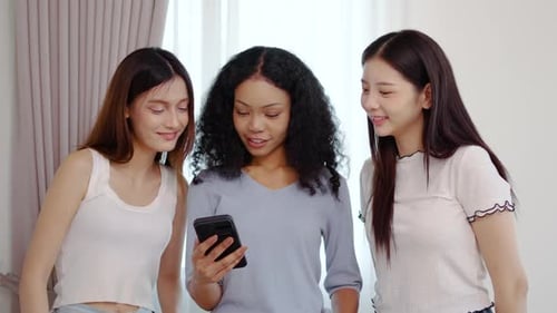 Three Young Women Using Smartphone Together