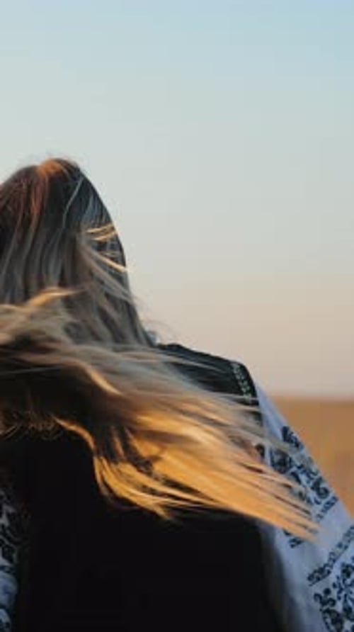 A Girl in a Wheat Field is Dancing A Silhouette of a Woman is Found Around Herself Standing in Wheat
