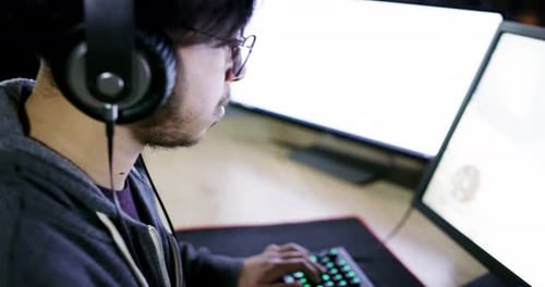 Gamer Playing on Computer at Night