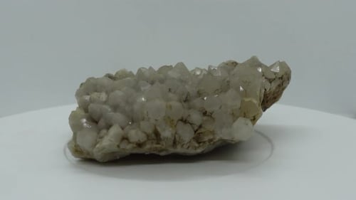Quartz Crystal Rock Rotating on White Surface