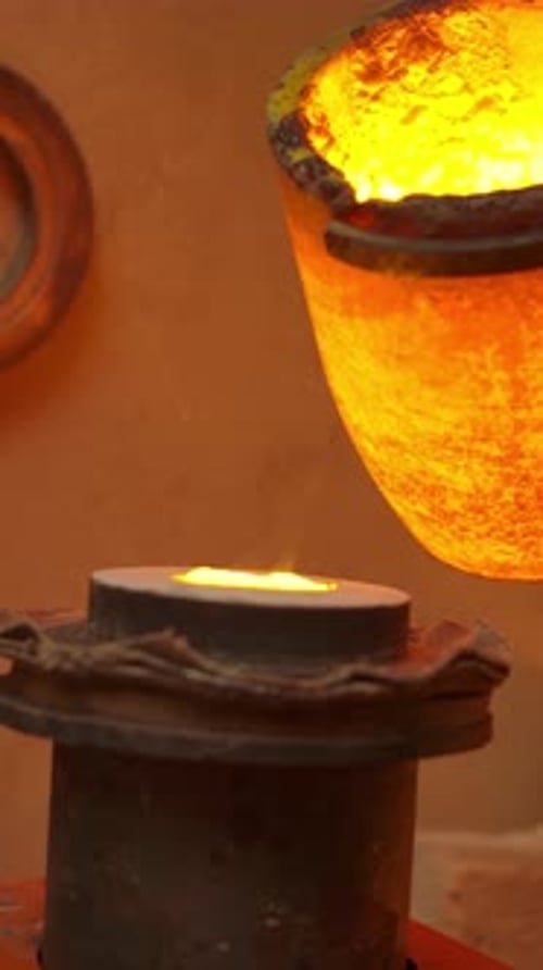 Vertical of Unrecognisable Master Pours Hot Metal Into the Form with Special Tongs