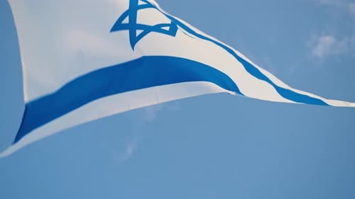 Israeli Flag Waving Against a Blue Sky