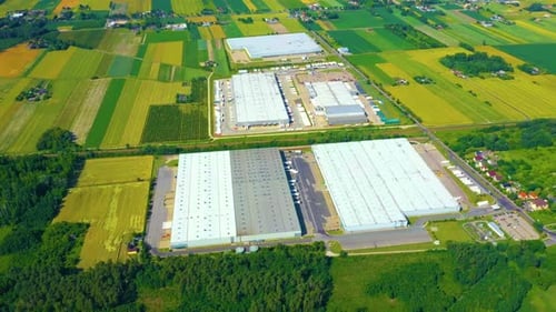 Aerial View of Modern Industrial Warehouse Complex in Rural Landscape