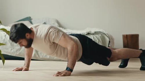 Young Bearded Man Doing Push Ups Exercising at Home