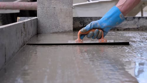 Hand Smoothing Wet Concrete with Tool