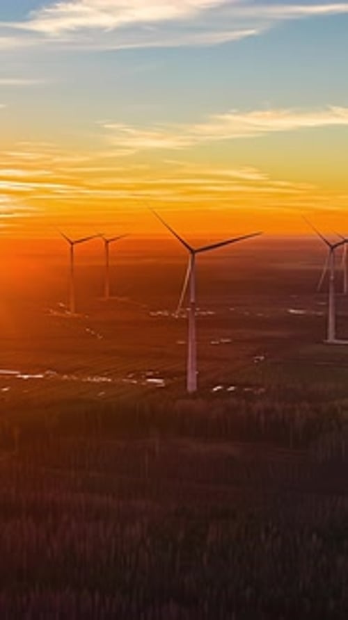 Wind Turbines at Golden Hour Turning Over Rural Landscape