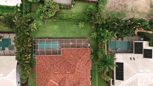 Aerial Above Wide View of Screened in Pool and Lanai in Florida House Top Down Shot