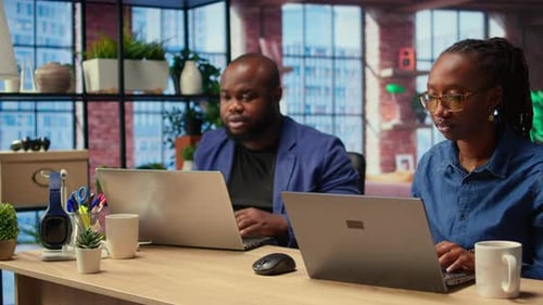 African American Couple Works From Home Collaborating on a Freelance Project