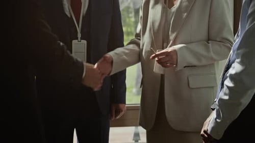 Business People Shaking Hands in Corporate Setting