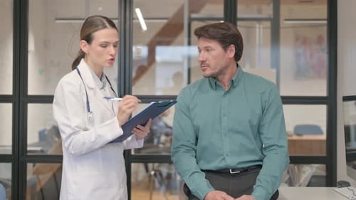 Doctor Consults With Man in Bright Office Setting