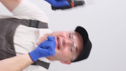 Enthusiastic Construction Worker Holding Drill Upright