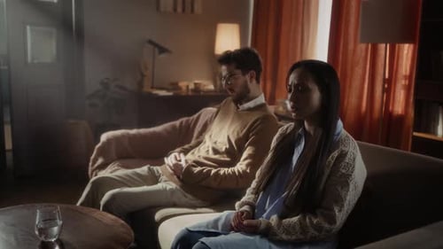 Sad Man and Woman in Quiet Living Room