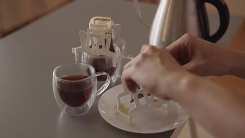 Drip Coffee Being Removed from Mugs onto Plate